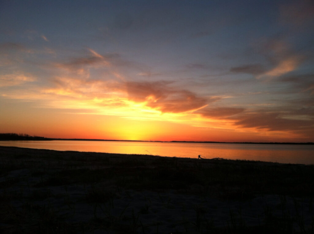 Orange, yellow and gold sunset over Cape Cod Bay